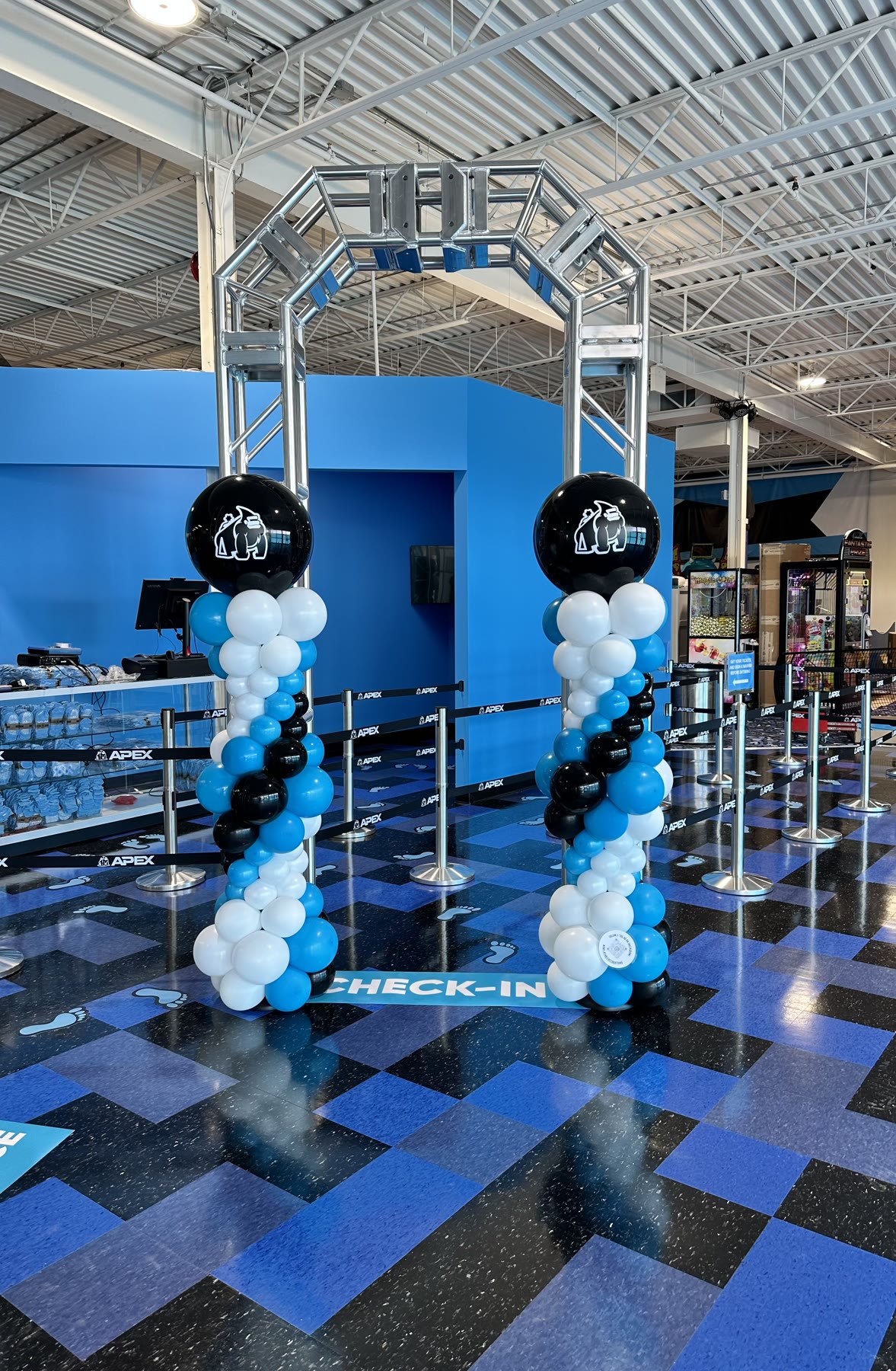 Blue and silver balloon garland on a corporate holiday party backdrop in Winnipeg