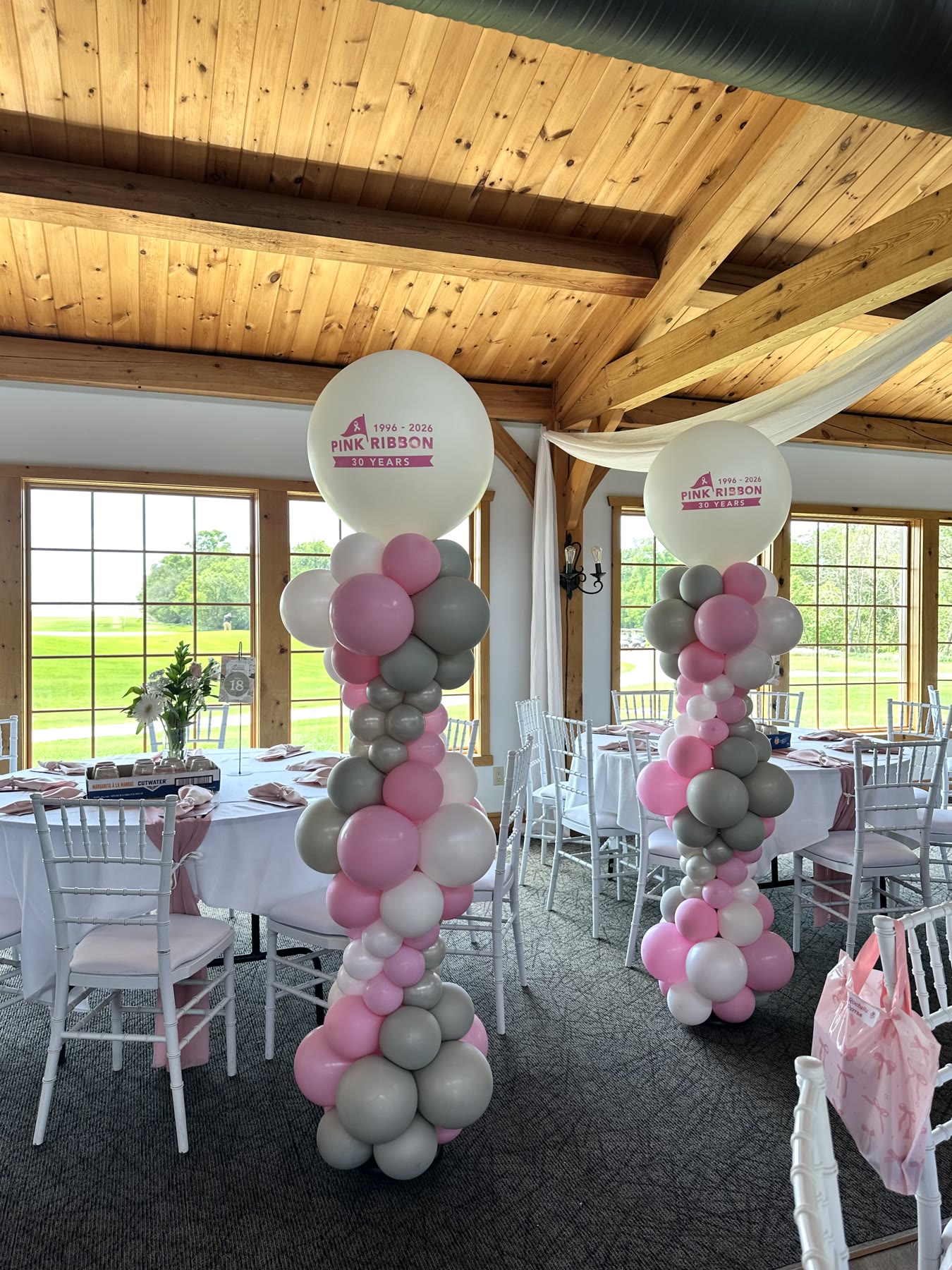Matched balloon columns with printed anniversary balloons at a Winnipeg fundraiser