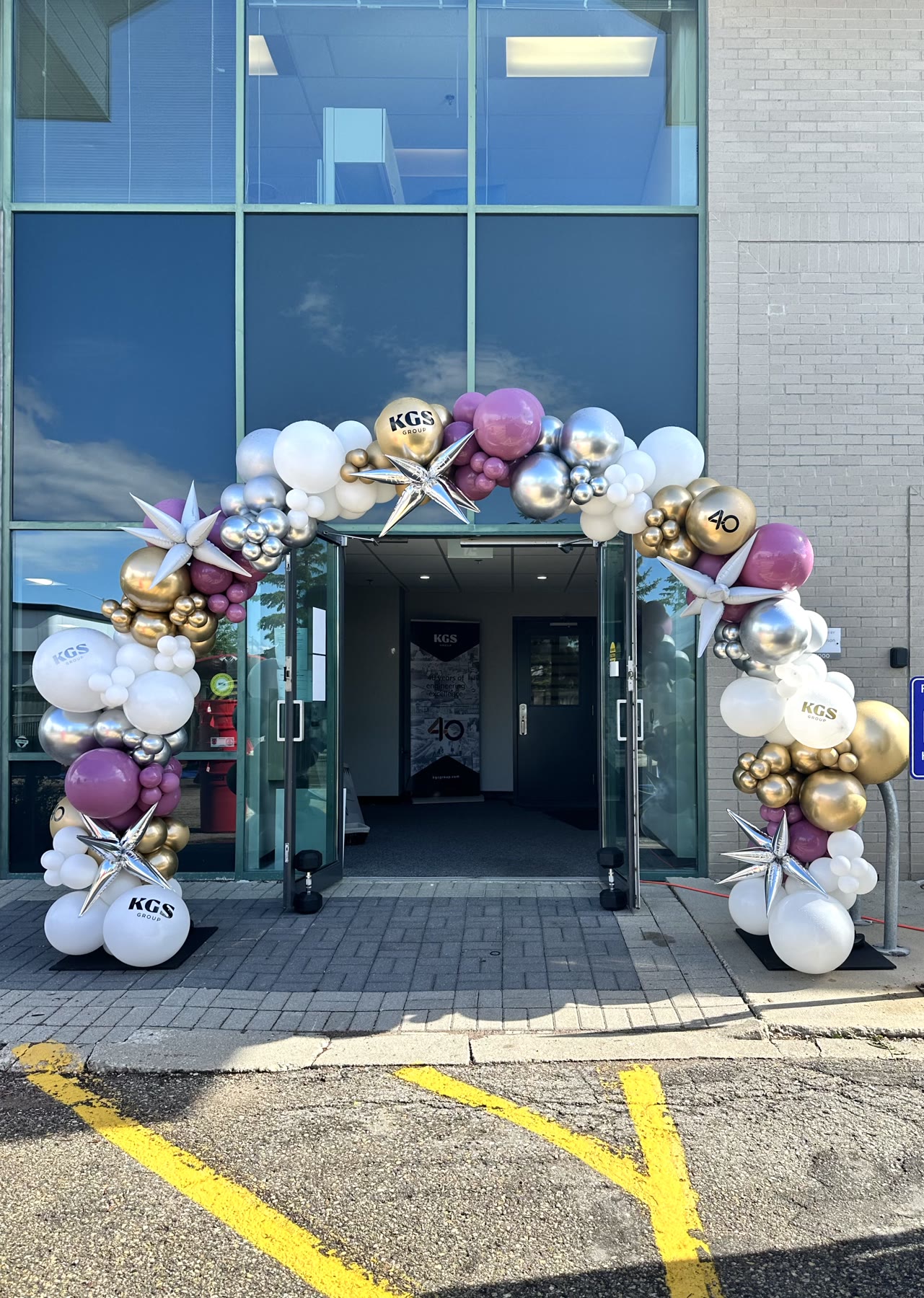 Custom walk-through balloon arch at a Winnipeg office entrance, built by Inflatable Decorations